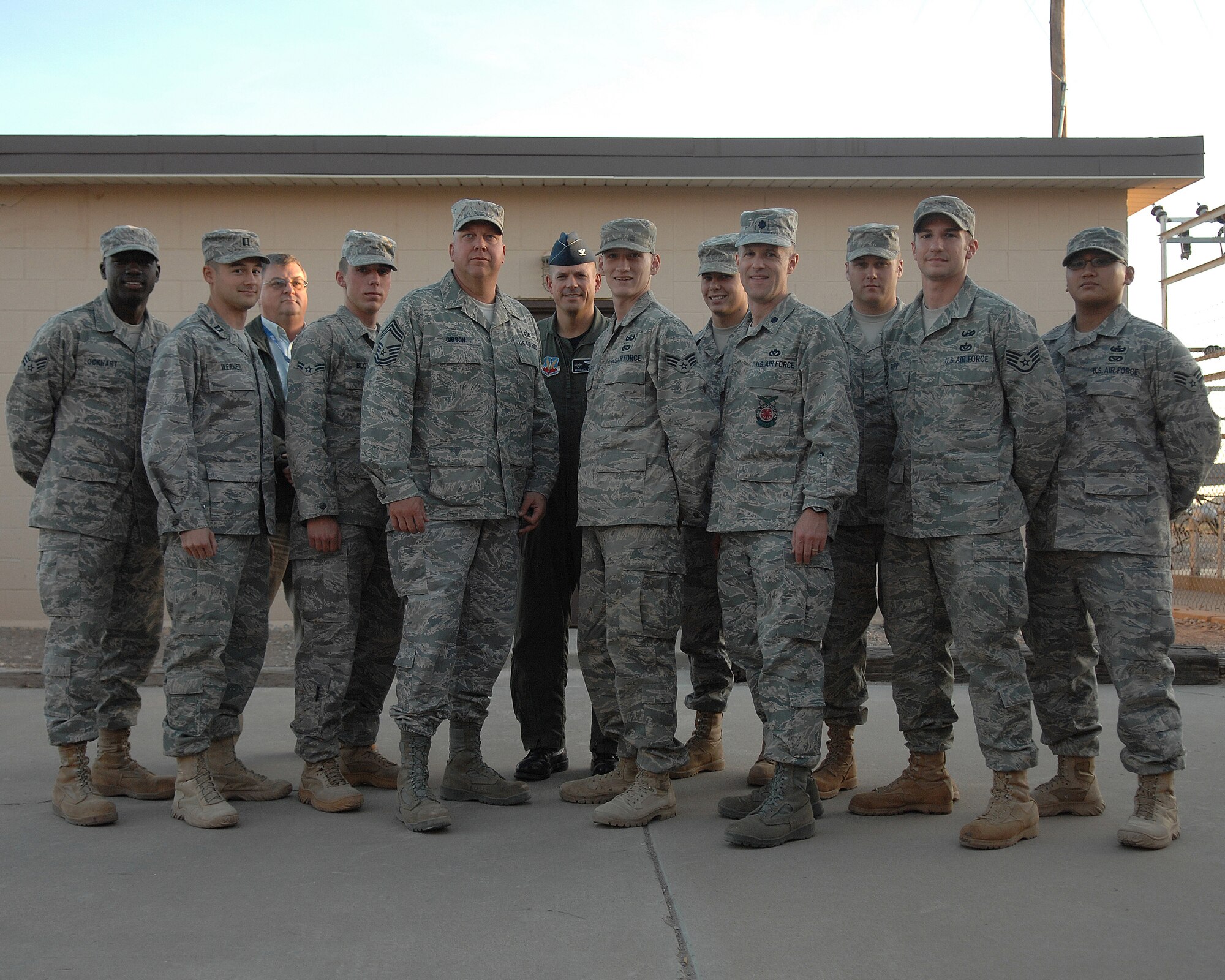 Col. Michael McGee, 49th Fighter Wing vice commander, poses for a group photo with a returning Airman from deployment, Nov. 13. Senior Airman Patrick Dougherty returned from a six month deployment to Afghanistan. Airman Dougherty is assigned to the 49th Civil Engineering Squadron at Holloman Air Force Base, N.M.

(U.S. photo/ Senior Airman Anthony Nelson Jr)
