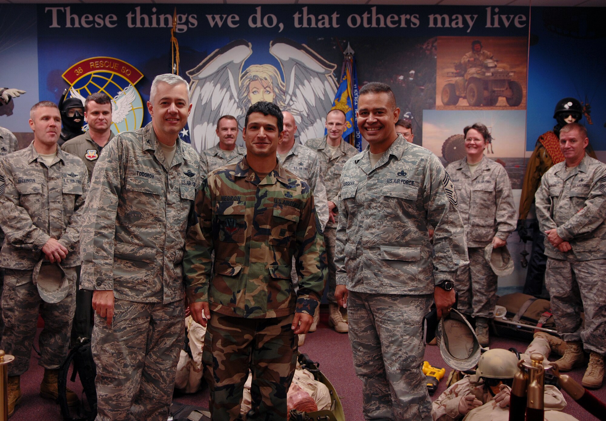 MOODY AIR FORCE BASE, Ga. -- (Left) Col. Kenneth Todorov, 23rd Wing commander, and (Right) Chief Master Sgt. Paul Burgess, 23rd Wing command chief master sergeant, congratulate Senior Master Sgt. Anthony Negron, 38th Rescue Squadron pararescueman, on being selected for promotion here Nov. 12. Sergeant Negron is one of eight members selected from Moody for promotion to chief master sergeant. (U.S. Air Force photo by Airman Joshua Green) 

