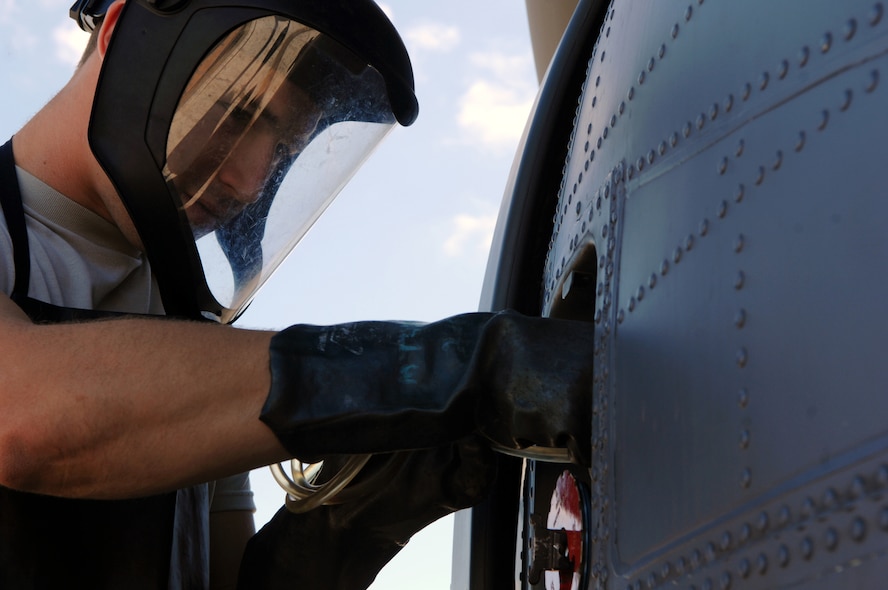 MOODY AIR FORCE BASE, Ga. – Airman Ryan Boyette, 723rd Aircraft Maintenance Squadron crew chief, inserts a tube into an HH-60G Pave Hawk gas tank here Nov. 6. Airman Boyette extracts fuel in preparation for a modification test on the aircraft. (U.S. Air Force photo by Airman Joshua Green)