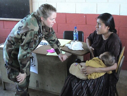 Lt. Col. (Dr.) Colleen Kelley talks with a mother during the colonel's deployment to Guatemala. Colonel Kelley is the chief of flight medicine with the 439th Aerospace Medicine Squadron. A reservist from Vermont, she spent two weeks in Guatemala in 2005, treating patients in remote clinics with the 710th Medical Squadron from Omaha, Neb. Two years later, she was part of a combined medical missionary mission to Bizerte, Tunisia, at Kharouba Air Base, where she trained with the Tunisian military, teaching aeromedical transport concepts. (Courtesy photo)