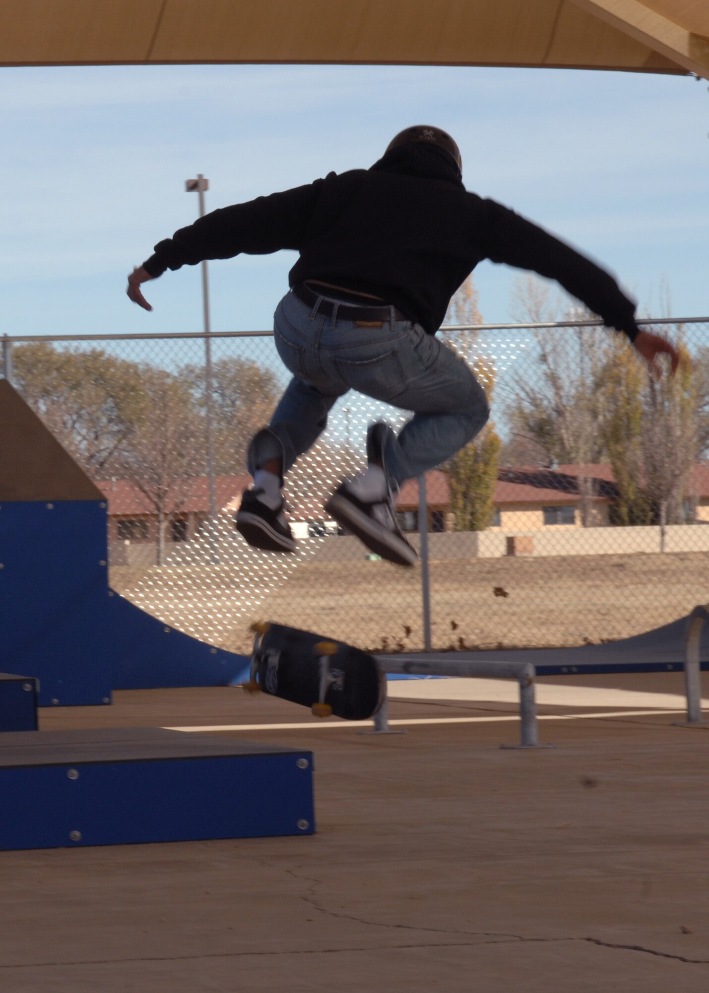 CANNON AIR FORCE BASE N. M. -- Airman 1st Class Jodan Stockdale, 27th Special Operations Comptroller Squadron, attempts a kickflip backside 50-50 at the new skate park located in Doc Stewart Park Nov. 15. The base communities were allowed in immediately after the ribbon cutting to take advantage of the new facility.  (U.S. Air Force photo by Airman 1st Class James R. Bell) 