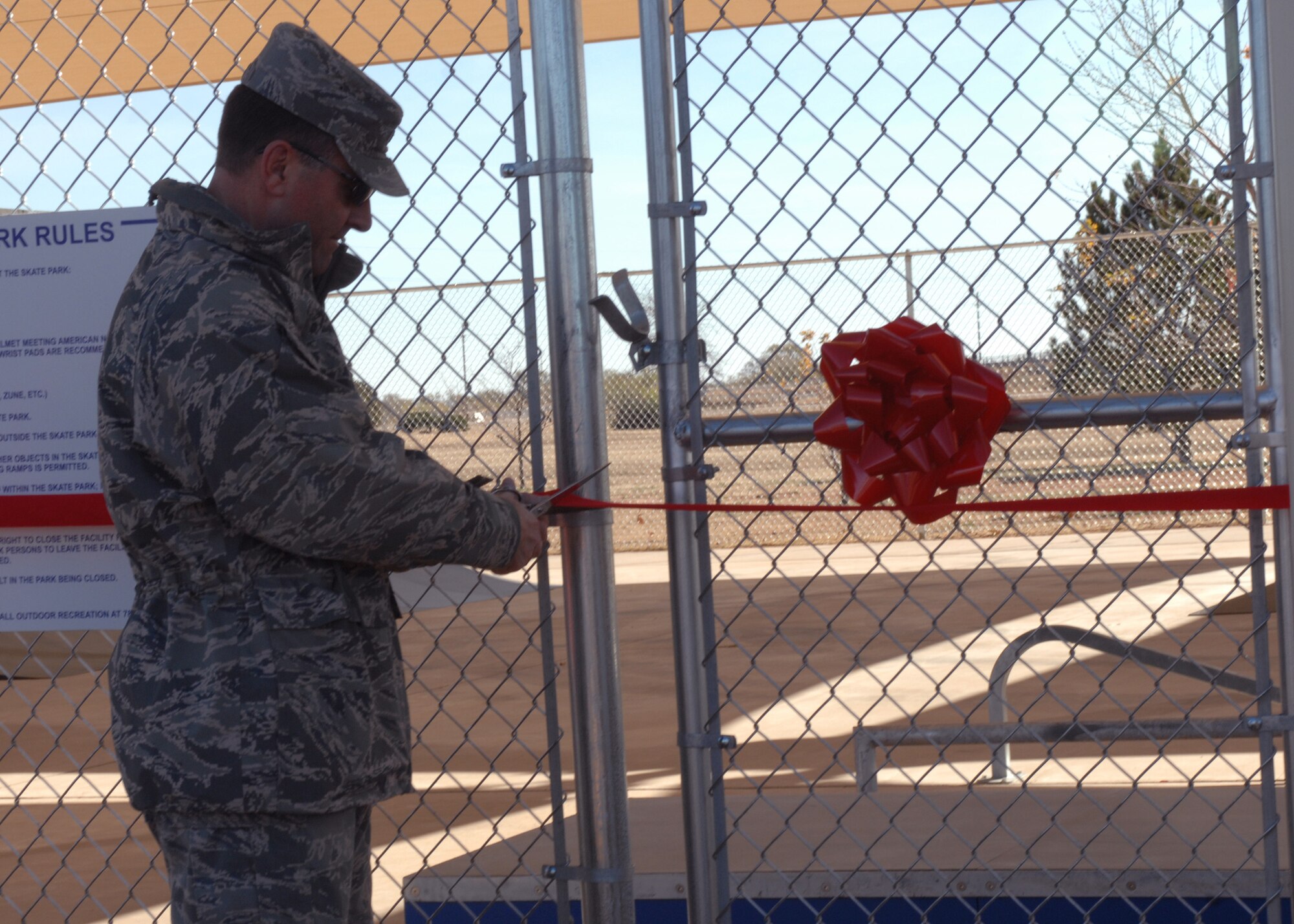 CANNON AIR FORCE BASE N.M. -- Col. Timothy Leahy, 27th Special Operations Wing commander, cuts the ribbon declaring the Doc Stewart Park's skate park's grand opening Nov. 15. Skaters are required to wear a helmet with some other optional safety gear.  (U.S. Air Force photo by Airman 1st Class James R. Bell)