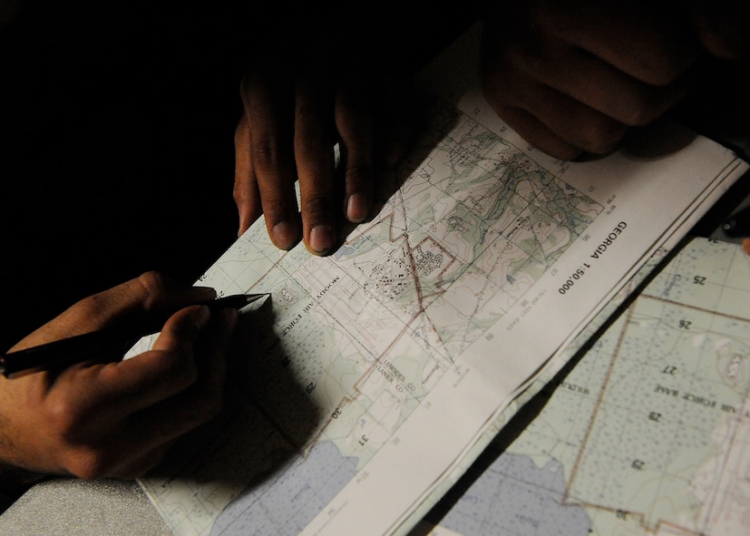 MOODY AIR FORCE BASE, Ga. – Airmen participating in training draw out plans on maps before participating in a patrol here Nov. 14. (U.S. Air Force photo by Senior Airman Brittany Barker) 