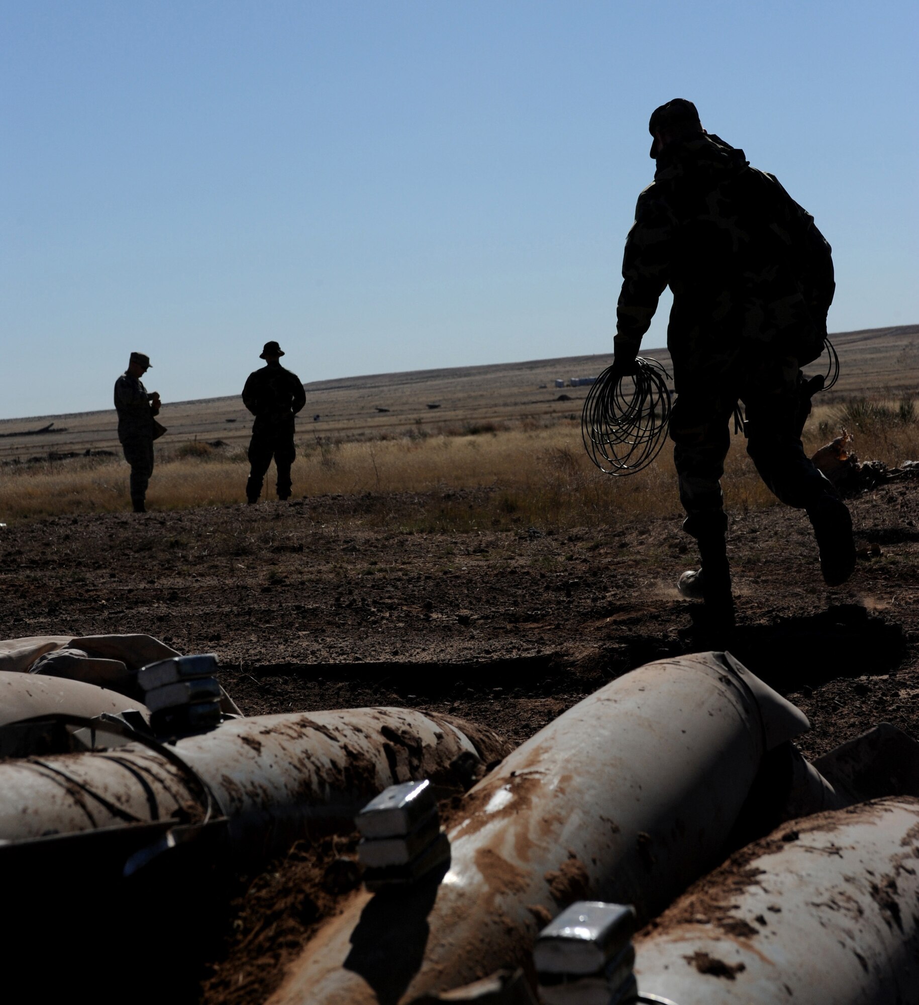 CANNON AIR FORCE BASE, N.M. - Airmen from the  27th Special Operations Civil Engineer Squadron's Explosive Ordnance Disposal flight plant demolition charges Nov 6. The EOD flight was performing their annual ordnance clearing at Melrose Air Force Range. (U.S. Air Force photo/Airman 1st Class Evelyn Chavez)