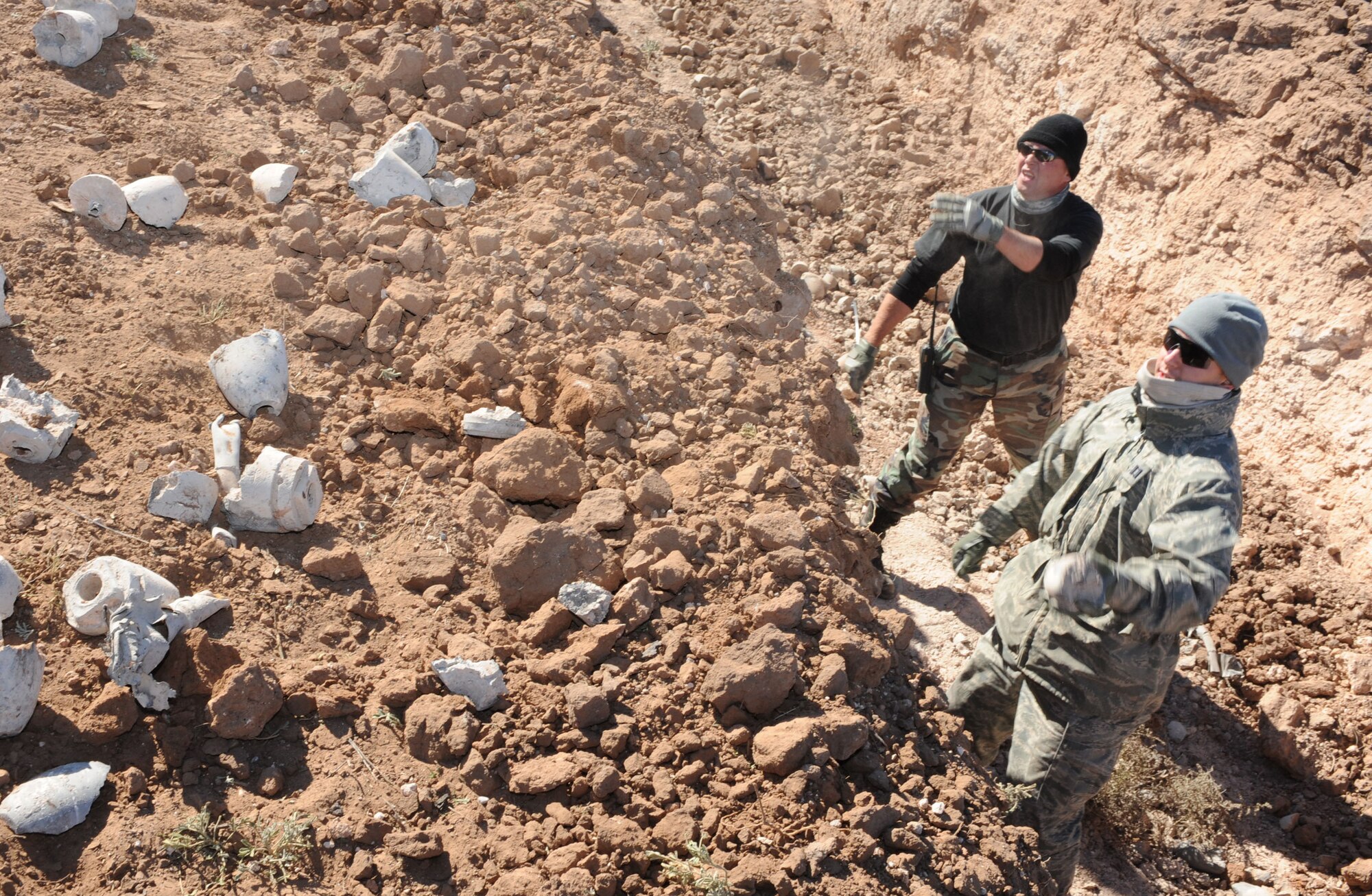 CANNON AIR FORCE BASE, N.M. -- Capt. David Troxell and Staff Sgt. Dennis Johnson, 27th Special Operations Civil Engineer Squadron's Explosive Ordnance Disposal Flight, clean up left over ordnance Nov 6.  The EOD Airmen perform and manage explosive ordance disposal operations. (U.S. Air Force photo/Airman 1st Class Evelyn Chavez)