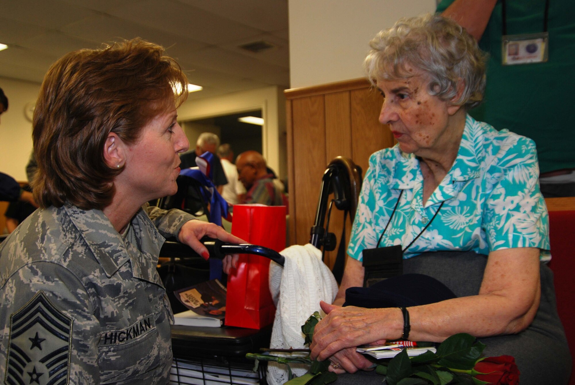 Chief Master Sgt. Patti Hickman, 459 Air Refueling Wing command chief discusses past military assignments with a resident of the Armed Forces Retirement Home during a wing-wide visit in honor of Veterans Day.  Coordinated by the Chaplin's office, members of the 459th ARW visit the Armed Forces Retirement home twice a year to share stories and spend time with residents. (U.S. Air Force Photo/Senior Airman Sasha S. Skrine