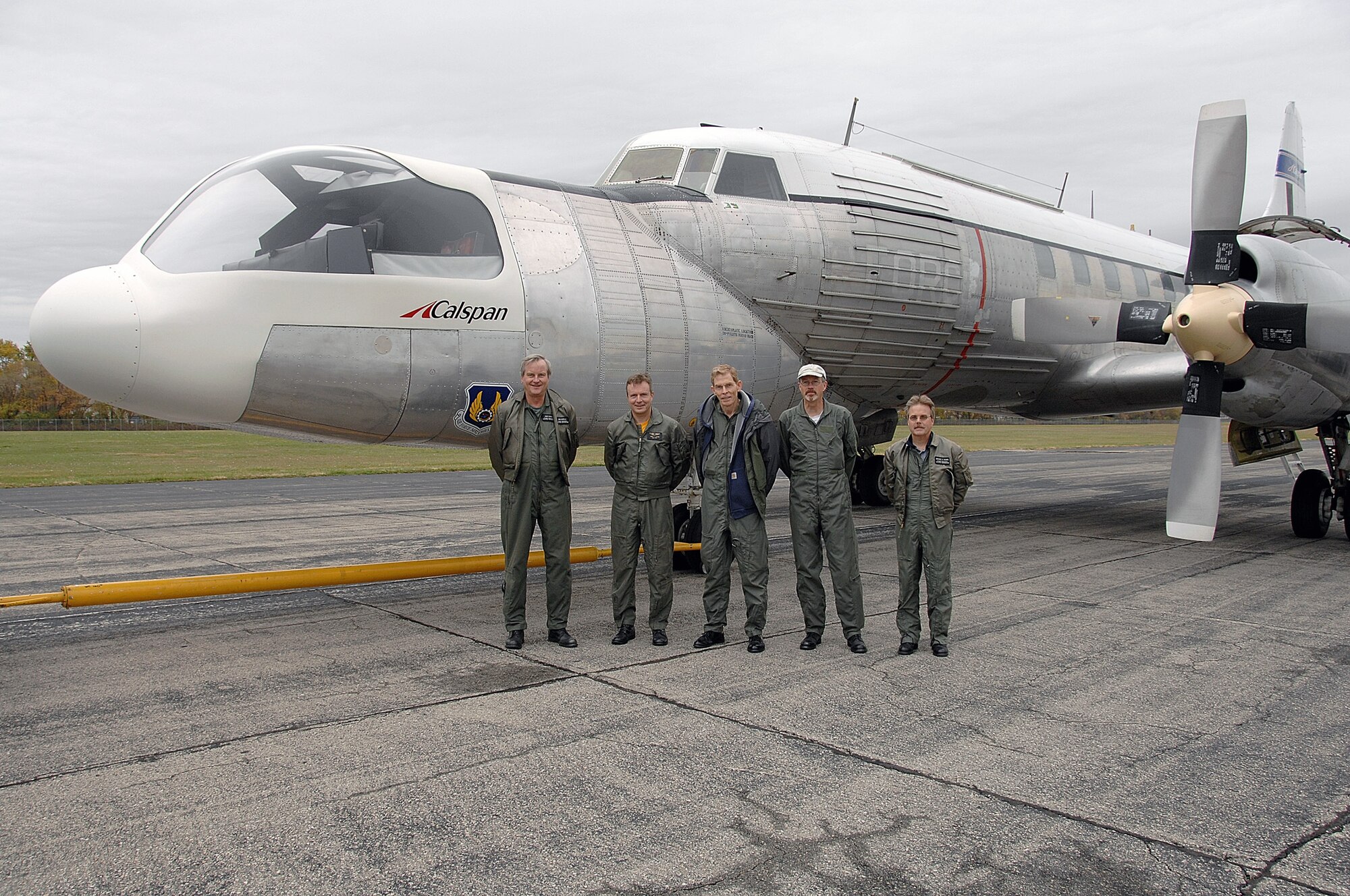 The crew for the final flight of the U.S. Air Force C-131 known as the Total-In-Flight Simulator pose with the aircraft Nov. 7 near a restoration hangar at Wright-Patterson Air Force Base, Ohio. The unusual aircraft flew some 2,500 research flights and contributed to the advancement of many of the flight technologies integral to today's fleet. Prior to its retirement, the TIFS, a 1955 Convair, was the oldest operating aircraft in the Air Force inventory.  (U.S. Air Force photo/Ben Strasser)