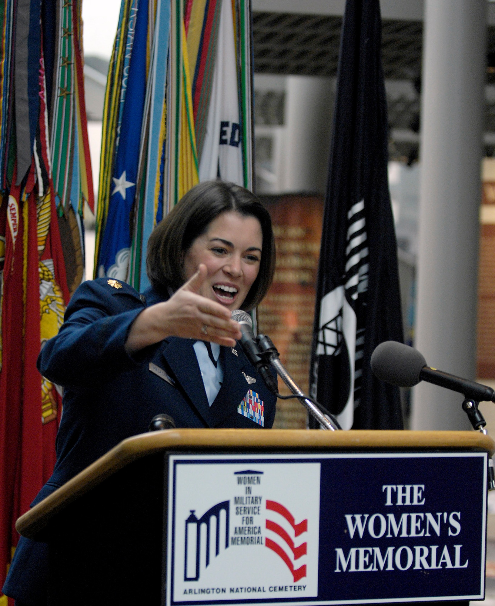 Maj. Nicole Malachowski, the first female pilot to fly with the U.S. Air Force Thunderbirds demonstration team, speaks to World War II Women Airforce Service Pilots during the "Fly Girls of World War II" exhibit which opened in their honor Nov. 14 at the Women in Military Service for America Memorial in Arlington, Va.  Approximately 25 WASPs attended the opening ceremony.  WASPs were the first U.S. military-trained women aviators in history.  (U.S. Air Force photo/Scott M. Ash)