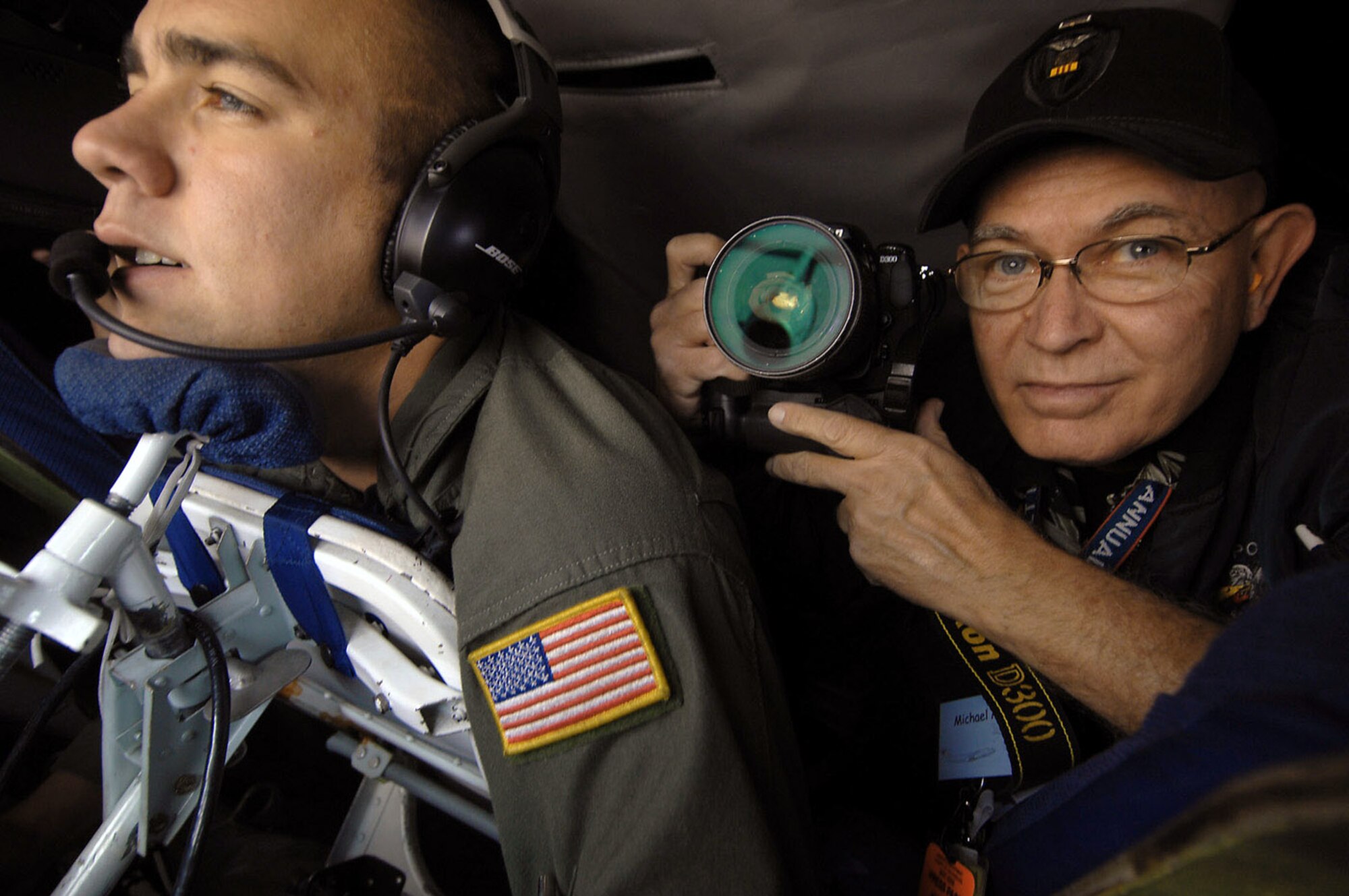 Mike Mullen (right) photographs Senior Airman Terry Mossbarger during an aerial refueling mission aboard a KC-135 Stratotanker Nov. 12 out of March Air Reserve Base, Calif. Airman Mossbarger is a boom operator from the 336th Air Refueling Squadron. Mr. Mullen is from the San Gabriel Valley Newspaper Group. (U.S. Air Force photo/Master Sgt. Rick Sforza) 
