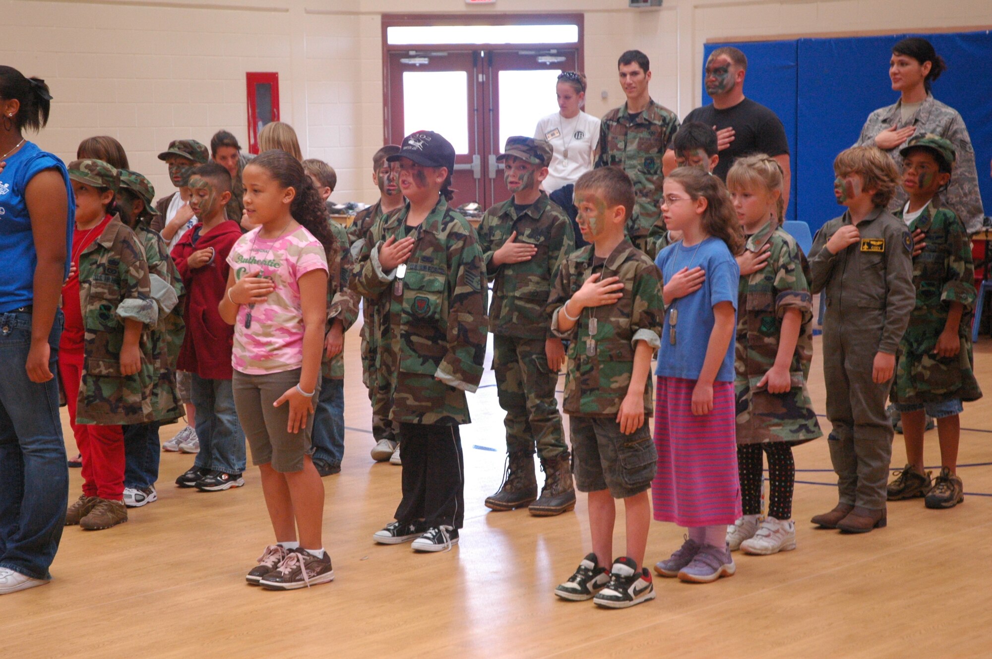 Children from Tyndall AFB stand in formation to pledge allegiance while participating in the JRAPTOR event Saturday.   JRAPTOR stands for Junior Real Air Patriots Training On Readiness, an annual event where children simulate deployment preparation.  (U.S. Air Force photo by Airman 1st Class Veronica McMahon) 