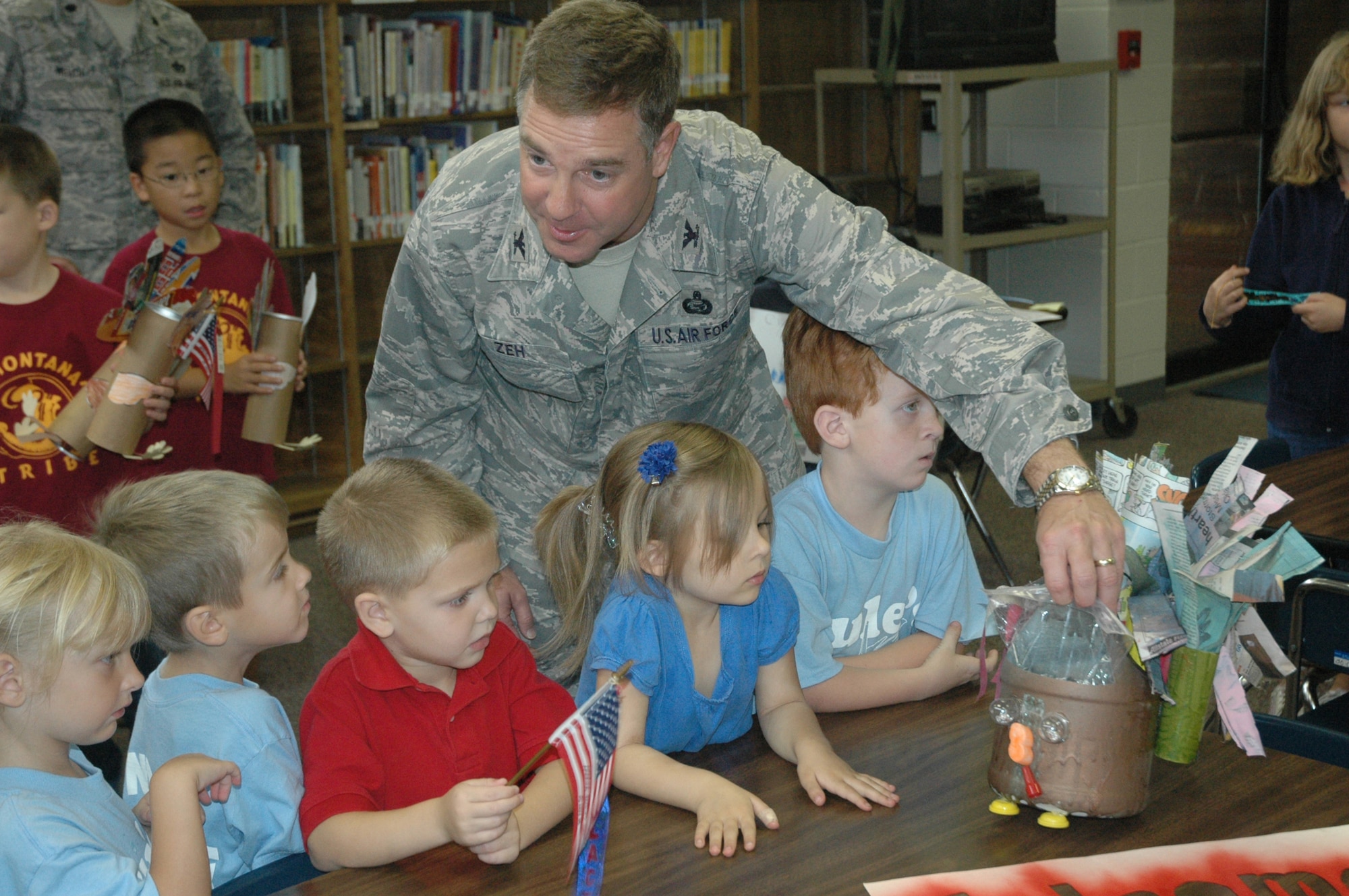 Col. David Zeh, 325th Mission Support Group commander, questions the Tyndall Elementary School kindergartners about their recycling project Friday.  (U.S. Air Force photo by Airman 1st Class Anthony J. Hyatt)