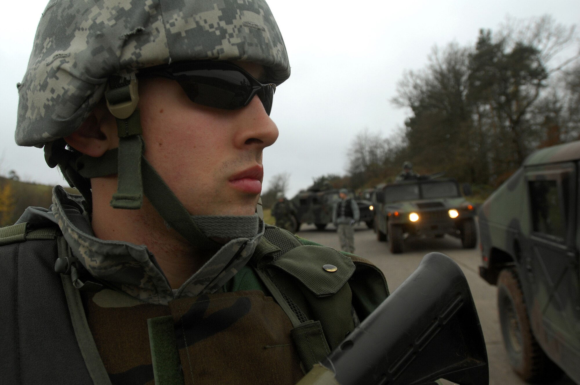 Airman 1st Class Tyler McEuin, 423rd Security Forces Squadron, Royal Air Force Alconbury, walks along aside a convoy during a Mounted Operations exercise, Nov. 15, 2008, Baumholder, Germany. During this two-day exercise, students were taught convoy and patrol techniques.  (U.S. Air Force photo Airman 1st Class Kenny Holston)