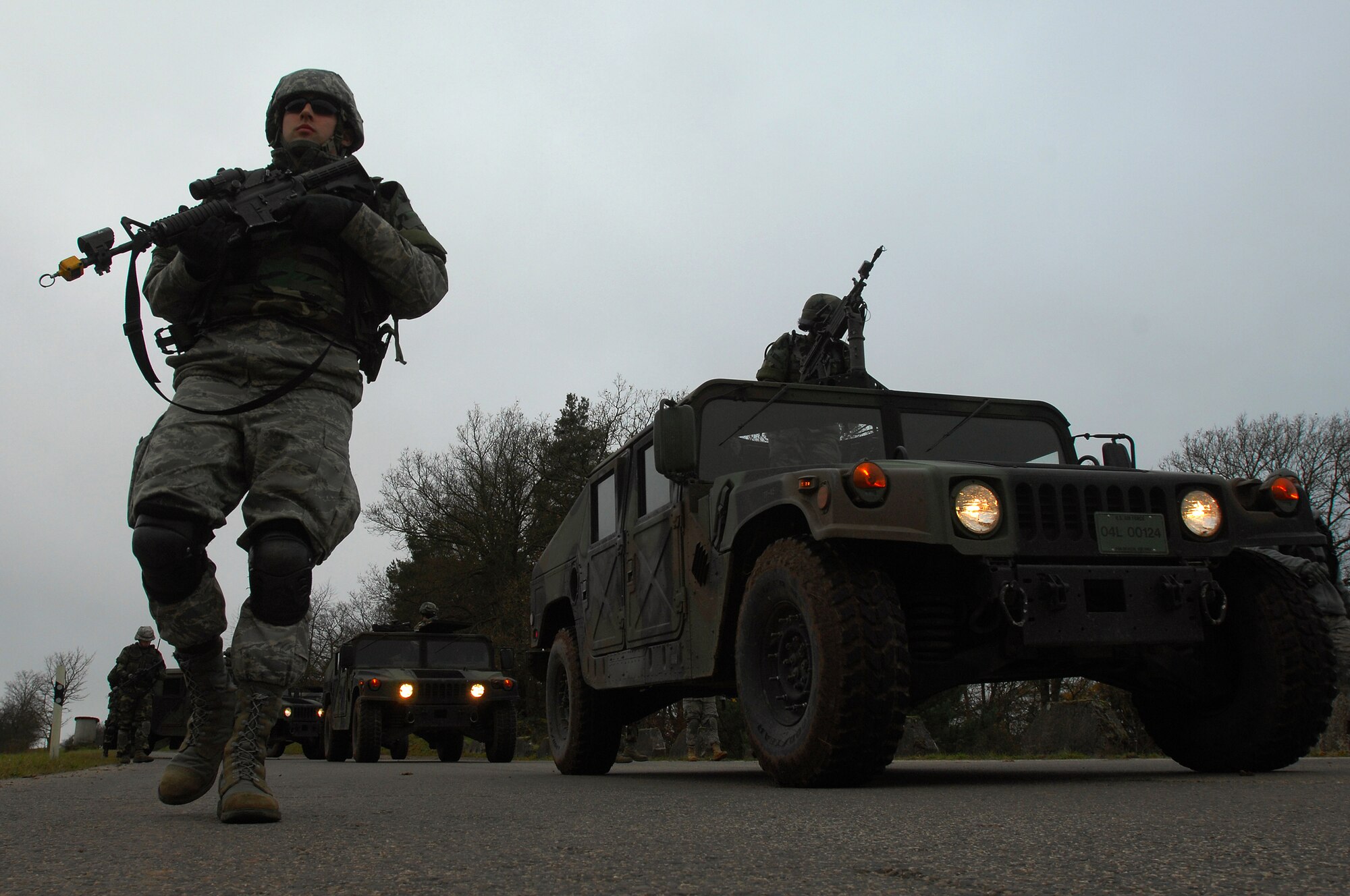 Airman 1st Class Tyler McEuin, 423rd Security Forces Squadron, Royal Air Force Alconbury, walks along aside a convoy during a Mounted Operations exercise, Nov. 15, 2008, Baumholder, Germany. During this two-day exercise, students were taught convoy and patrol techniques.  (U.S. Air Force photo Airman 1st Class Kenny Holston)
