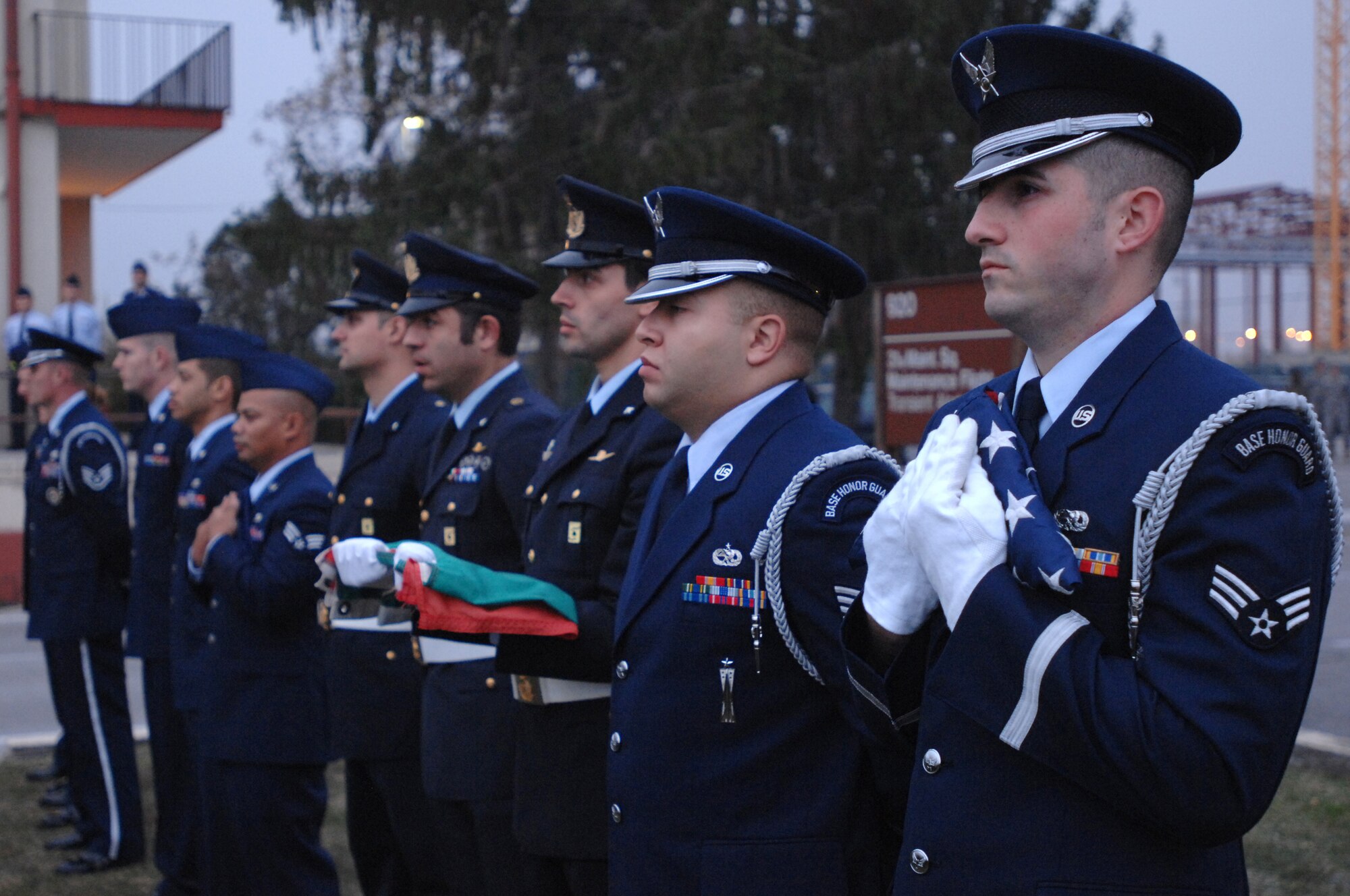 Aviano Honorguardsmen Senior Ariman Ryan O'Toole (right) and Staff Sgt. Eli Barnett join other Veterans Day retreat ceremony participants Nov. 10 as they listen to the closing ceremony remarks. More than 100 U.S. and Italian Air Force members and civilians joined in the observance.(U.S. Air Force photo/Staff Sgt. Patrick Dixon)