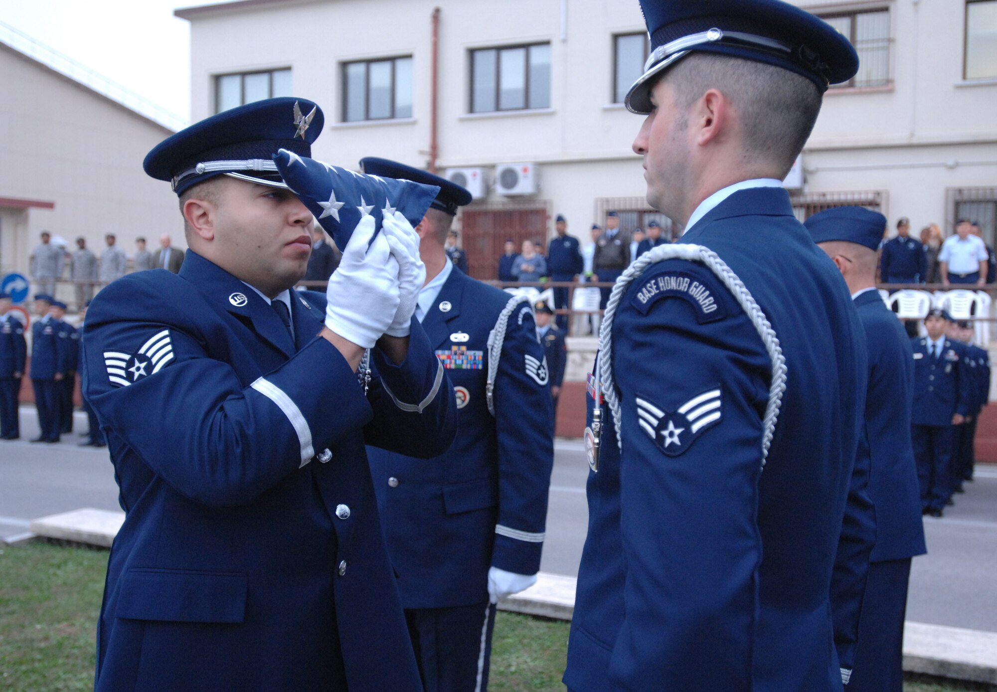 Honorguardsmen Staff Sgt. Eli Barnett and Senior Ariman Ryan O'Toole perform in the base Veterans Day retreat ceremony Nov. 10. More than 100 U.S. and Italian Air Force members and civilians joined in the observance. (U.S. Air Force photo/Staff Sgt. Patrick Dixon)