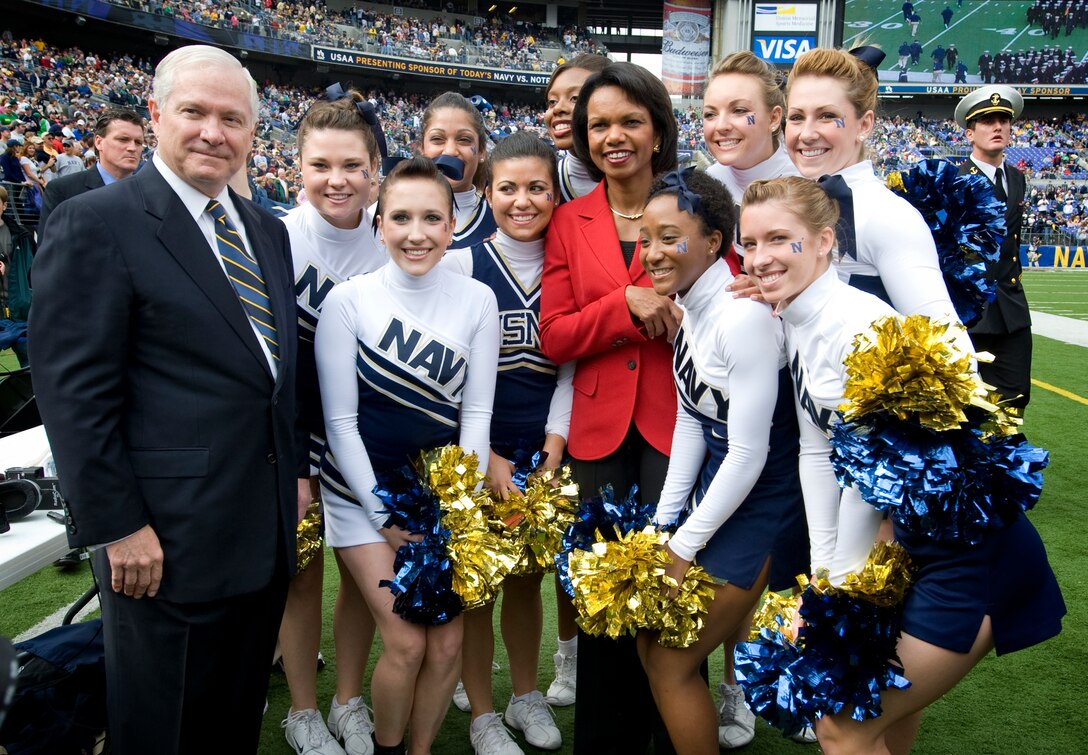 Defense Secretary Robert M. Gates and Secretary of State Condoleezza Rice take a photo with the Navy cheerleaders prior to the start of the Navy vs. Notre Dame football game in Baltimore, Nov. 15, 2008. 