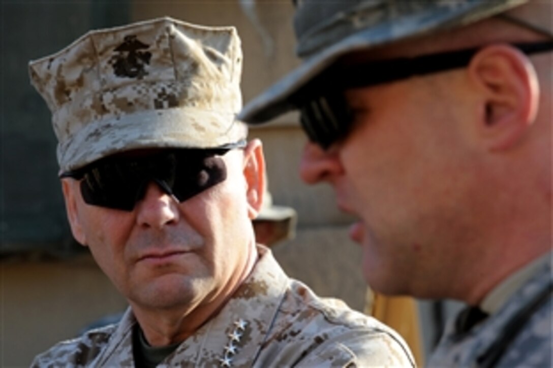 Vice Chairman of the Joint Chiefs of Staff U.S. Marine Gen. James E. Cartwright listens to Lt. Col. Michael Shrout, commander of the 2nd Battalion, 6th Infantry, 1st Armored Division during a stop at Combat Outpost Cahill, Iraq, Nov. 15, 2008. Cartwright visited the outpost to learn about operations and see living conditions. 