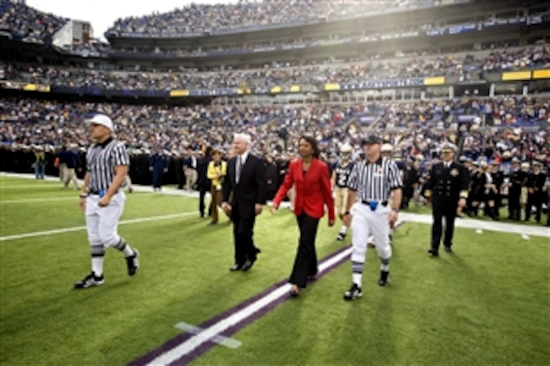 Defense Secretary Robert M. Gates and Secretary of State Condoleezza Rice walk out onto the field to participate in the coin toss prior to the start of the Navy vs. Notre Dame football game in Baltimore, Nov. 15, 2008. Notre Dame won, 27-21.