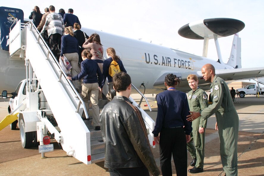Col. Patricia Hoffman, commander, 552nd Air Control Wing, and Capt. Brian Hardeman, air battle manager, 552nd Operations Group welcome DelQuest students onto the E-3 Sentry for a tour and a chance to talk with several crewmembers. Photo compliments of 1Lt Kinder Blacke.
