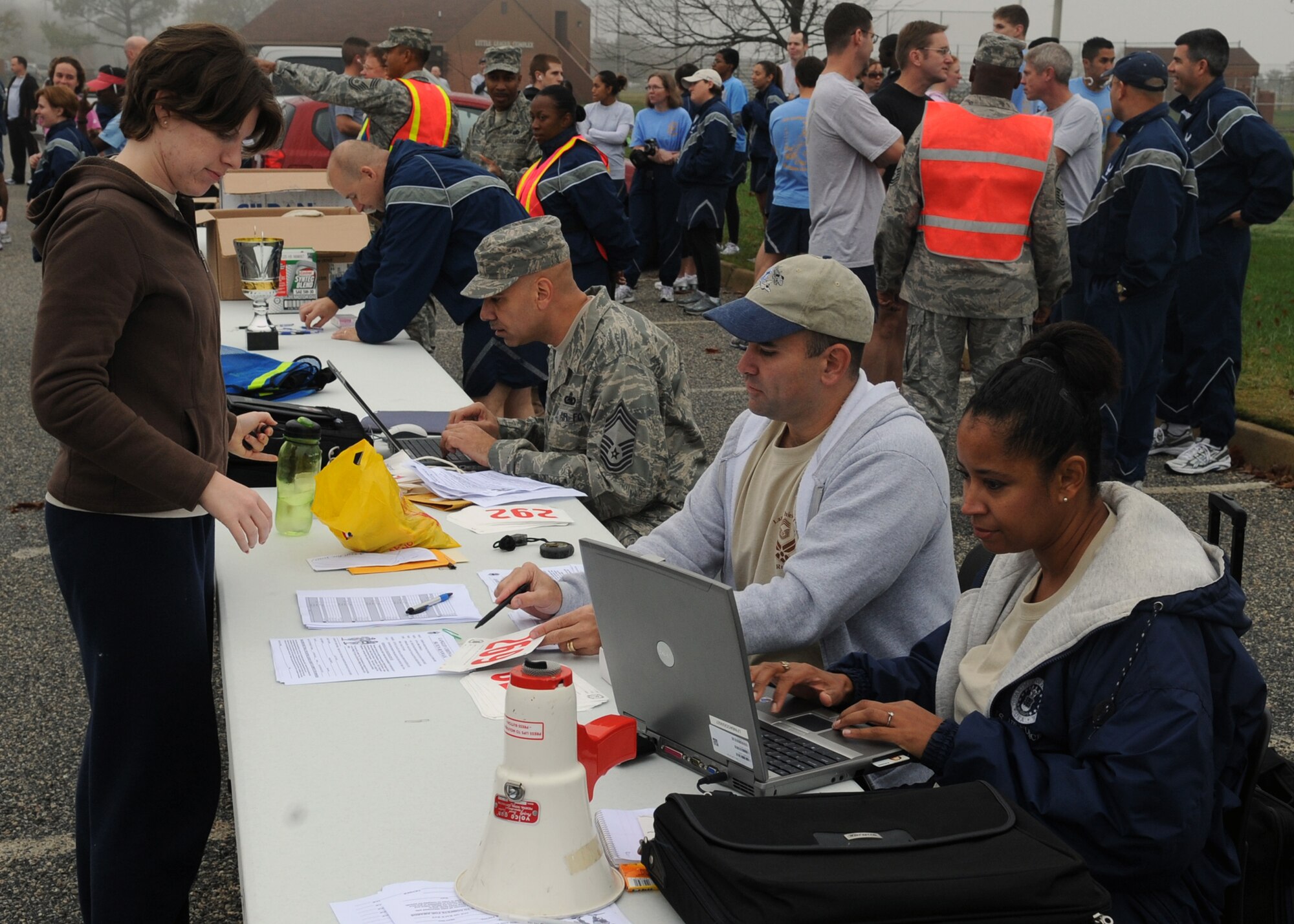 LANGLEY AIR FORCE BASE, Va. - 1st Lt. Lisa McIver, Air Combat Command executive officer, signs up for the Chief's Fun Run with Chief Master Sgt. John Evalle, 1st Mission Support Group superintendent and Chief Master Sgt. Robin Mosby, ACC electronic communications superintendent Nov. 15. The fun run, sponsored by the Chief's Group, raised approximately $500 to support a number of Team Langley enlisted programs. (U.S. Air Force photo/Airman 1st Class Jonathan Koob)