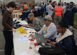 LANGLEY AIR FORCE BASE, Va. - 1st Lt. Lisa McIver, Air Combat Command executive officer, signs up for the Chief's Fun Run with Chief Master Sgt. John Evalle, 1st Mission Support Group superintendent and Chief Master Sgt. Robin Mosby, ACC electronic communications superintendent Nov. 15. The fun run, sponsored by the Chief's Group, raised approximately $500 to support a number of Team Langley enlisted programs. (U.S. Air Force photo/Airman 1st Class Jonathan Koob)