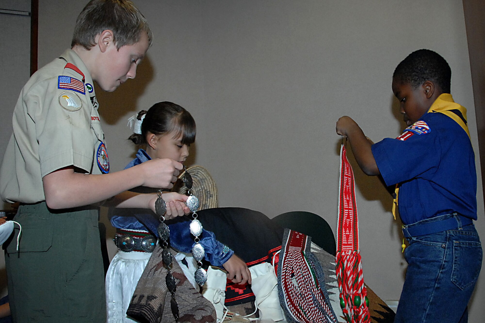 OFFUTT AIR FORCE BASE, Neb. --  Kyle Hefner, a member of Boy Scout Troop 305, and son of Ron Hefner, a civilian with U.S. Strategic Command, and Henry Larweh, a cub scout in Pack 91, son of Maxwell and Patience Larweh, look at some Navajo made items at a Native American story telling event at the library here Nov. 15.  Briana Rehm, who is half Navajo, assisted the boy scouts in their understanding of the Navajo culture both past and present.   (U.S. Air Force Photo By Kendra Williams)