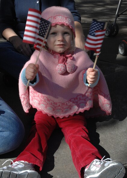 ABILENE, Texas -- A young girl waves her American flags as she cheers for Dyess Airmen at the Veteran's Day Parade Nov 15. (U.S. Air Force photo/ Senior Airman Jennifer Romig)