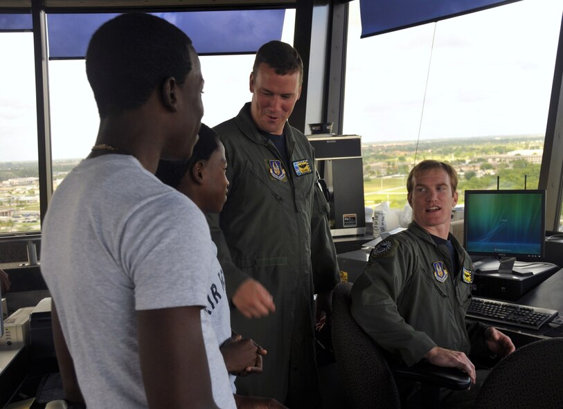 F-16 pilots from the 93rd Fighter Squadron, Maj. David Sundlov, center, and Maj. Christopher Barth, answer questions from two students while visiting the Homestead ARB air traffic control tower on Nov. 14.   Forty Air Force Junior ROTC cadets from Homestead High School took part in one of two tours the base offers each month for students and community organizations to learn about the Air Force Reserve mission.  (U.S. Air Force photo/Tim Norton)