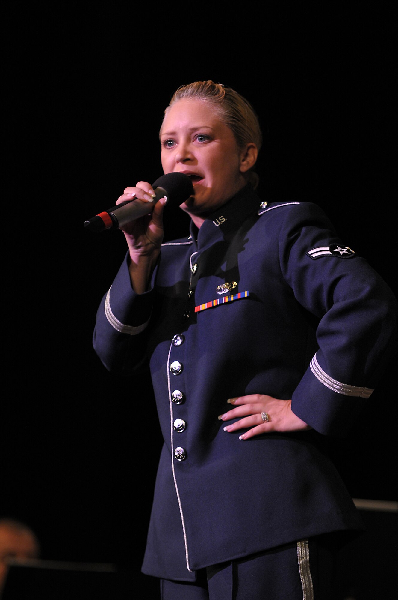 Airman First Class Pamela Kelly, vocalist with the Band of the Golden West, sings to a crowd at the Warner Grand Theater, Nov. 16. The concert is one of the various events through out Southern California during Air Force Week.   (Photo by Joe Juarez)