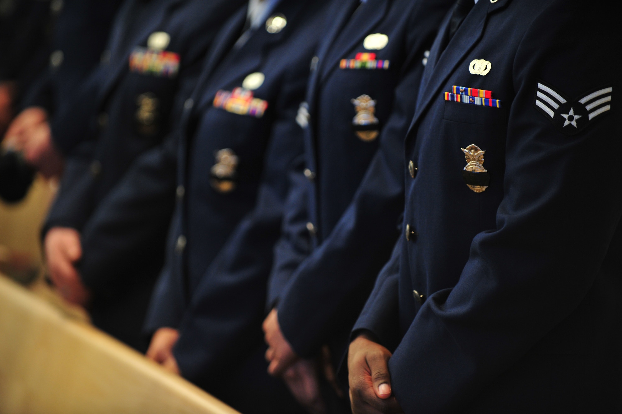 A black strip is placed over Security Forces badges to pay respect to a fallen comrade during Staff Sgt. Brandon Stagner's memorial service Nov. 14, 2008, Eielson Air Force Base, Alaska. Friends, family and co-workers gathered together to mourn the loss of Sergeant Stagner who served honorably for 14 years. He was assigned to the 354th Security Forces Squadron.  (U.S. Air Force photo/Senior Airman Jonathan Snyder)