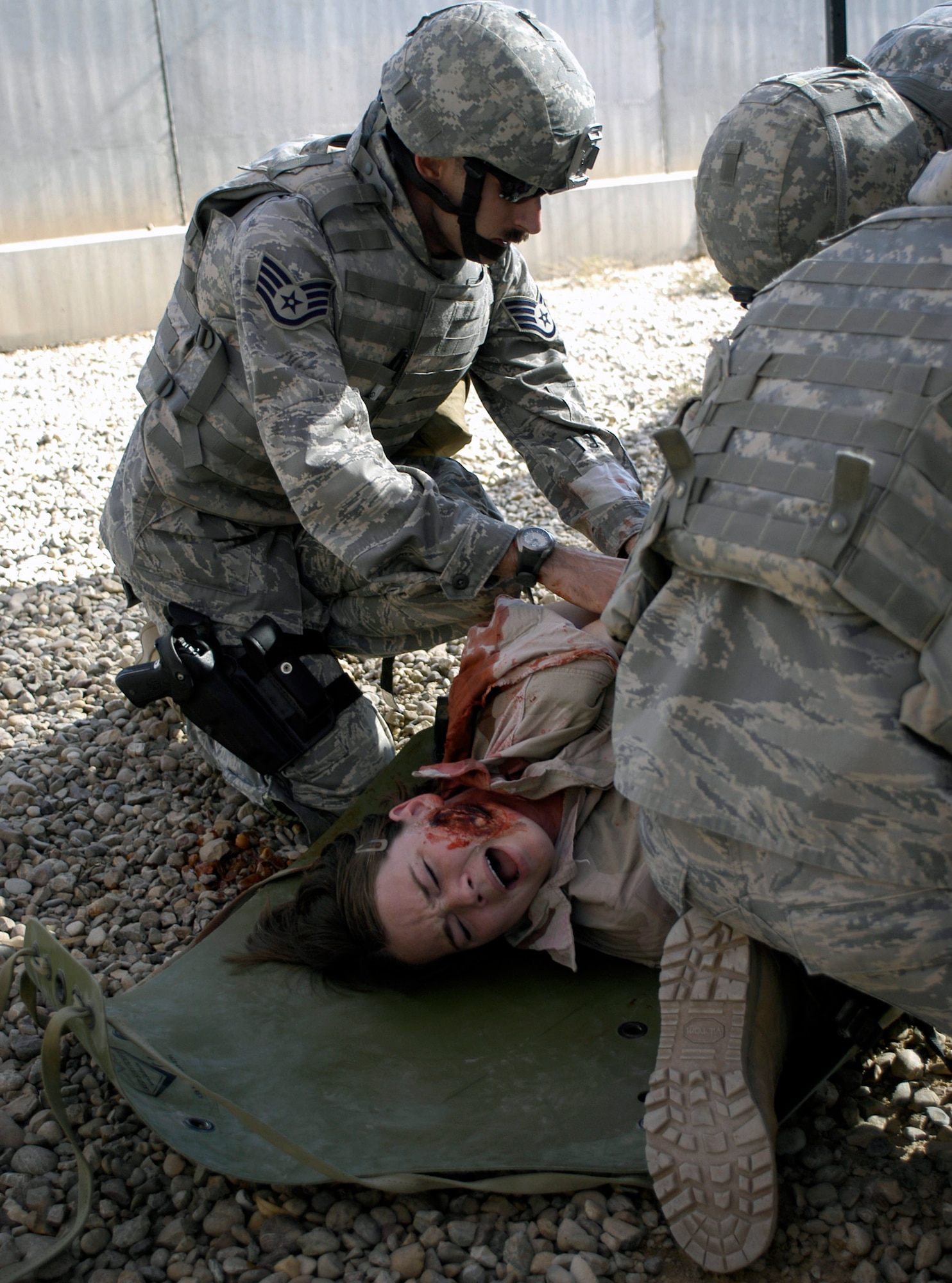 Staff Sgt. Rodney Franken coordinates treatment for a roleplayer who was simulated wounded for training Nov. 12 at Joint Base Balad, Iraq. Sergeant Franken is a security forces journeyman assigned to the 532nd Expeditionary Security Forces Squadron deployed from the 435th Security Forces Squadron, at Ramstien Air Force Base, Germany. He attended combat lifesaver training, which is a requirement for personnel in the 332nd Expeditionary Security Forces Group. (U.S. Air Force photo/Tech. Sgt. Craig Lifton) 