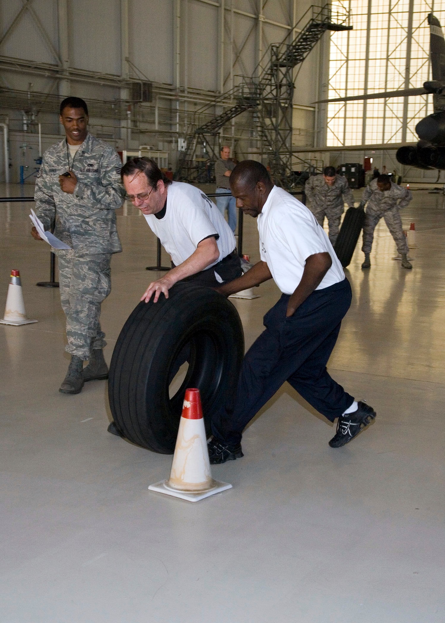 Maintainers roll large tires as part of the 412th Maintenance Group's Maintenance Olympics. After three hours of competition, the 412 Aircraft Maintenance Squadron came out as the victor and took home the highly-coveted first place 412th MXG Maintenance Olympics Wrench. The 412th Logistics Test Squadron took second while the 412th MXG staff took third. (Air Force photo by Chad Bellay)