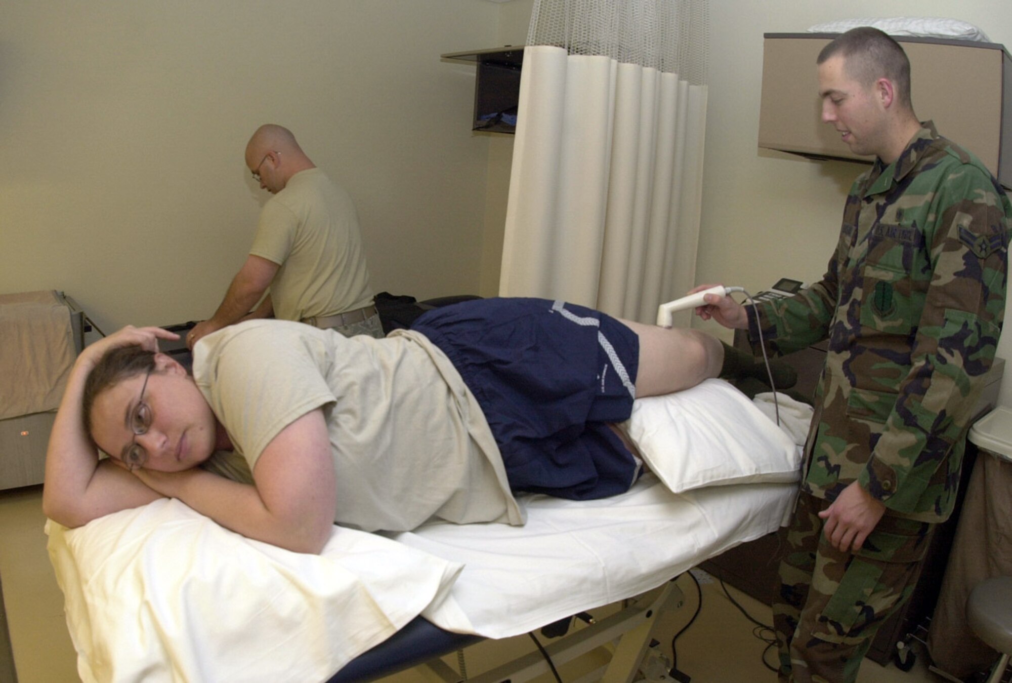 Airman 1st Class Sean Devereaux performs physical therapy via ultrasound on an injured knee ligament of Capt. Lara Kalin-Cristofori Oct. 29 at the 17th Medical Group Clinic at Goodfellow Air Force Base, Texas. Airman Devereaux is a 17th Medical Support Squadron physical therapy journeyman. (U.S. Air Force photo/Senior Airman Luis Loza Gutierrez) 
