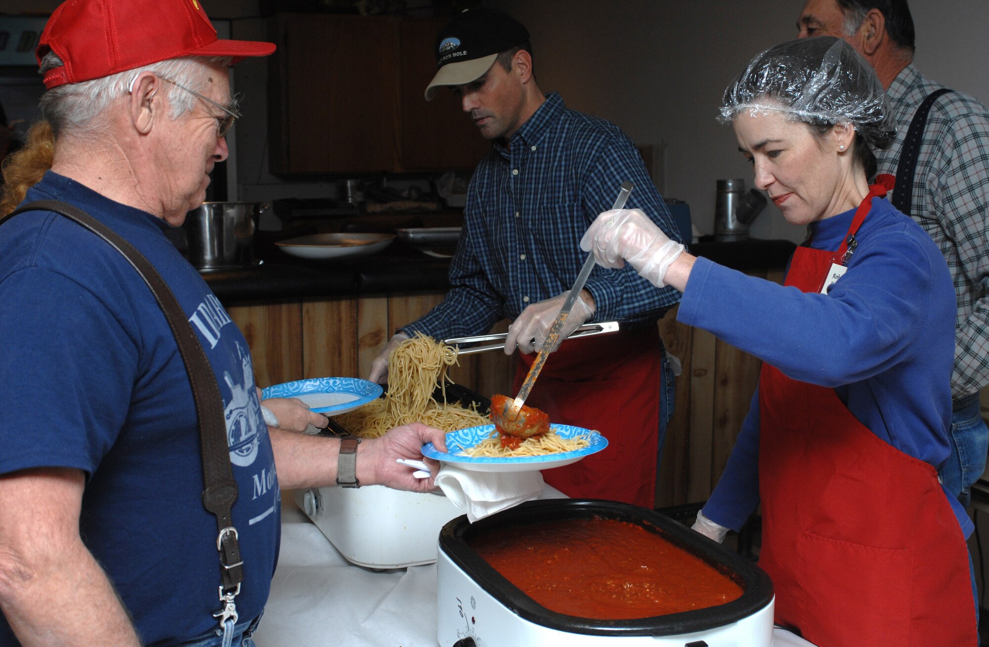 MOUNTAIN HOME AIR FORCE BASE, Idaho - Lt. Col. Robin Hunt, 366th Medical Group deputy commander, helps serve spaghetti to veterans at the spaghetti dinner hosted at the American Legion Post 26 Nov. 11. The dinner was put together by the 366th Medical Group Spouses honoring the veterans in Idaho. Idaho has the largest percent of veterans by population in the nation. (U.S. Air Force photo/ Airman Debbie Lockhart)