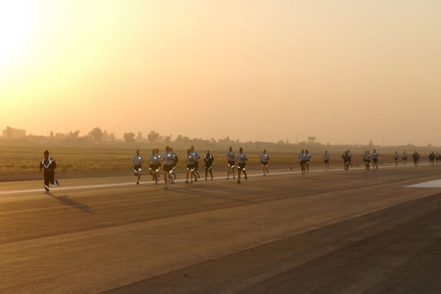 KIRKUK REGIONAL AIR BASE, Iraq –  The first rubber to actually touch the newly resurfaced 8,535-foot runway was not from an airplane, but rather the shoes of more than 100 Airmen who participated in a Runway Opening Fun Run. (U.S. Air Force photo/Master Sgt. Andrew Leonhard) 
