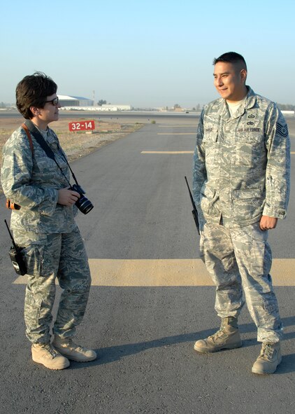 KIRKUK REGIONAL AIR BASE, Iraq –  Lt. Col. Elisabeth Auld, 506th Expeditionary Operational Support Squadron commander, and Tech. Sgt. Clint Harper, 506th EOSS airfield manager, talk about a couple of the small tasks to be completed on the new resurfaced runway 14/32 at Kirkuk Regional Air Base, Iraq, Nov. 17. The 8,535-foot runway was re-opened after three months of work by Red Horse and local civil engineer teams. (U.S. Air Force photo/ Master Sgt. Andrew Leonhard)  