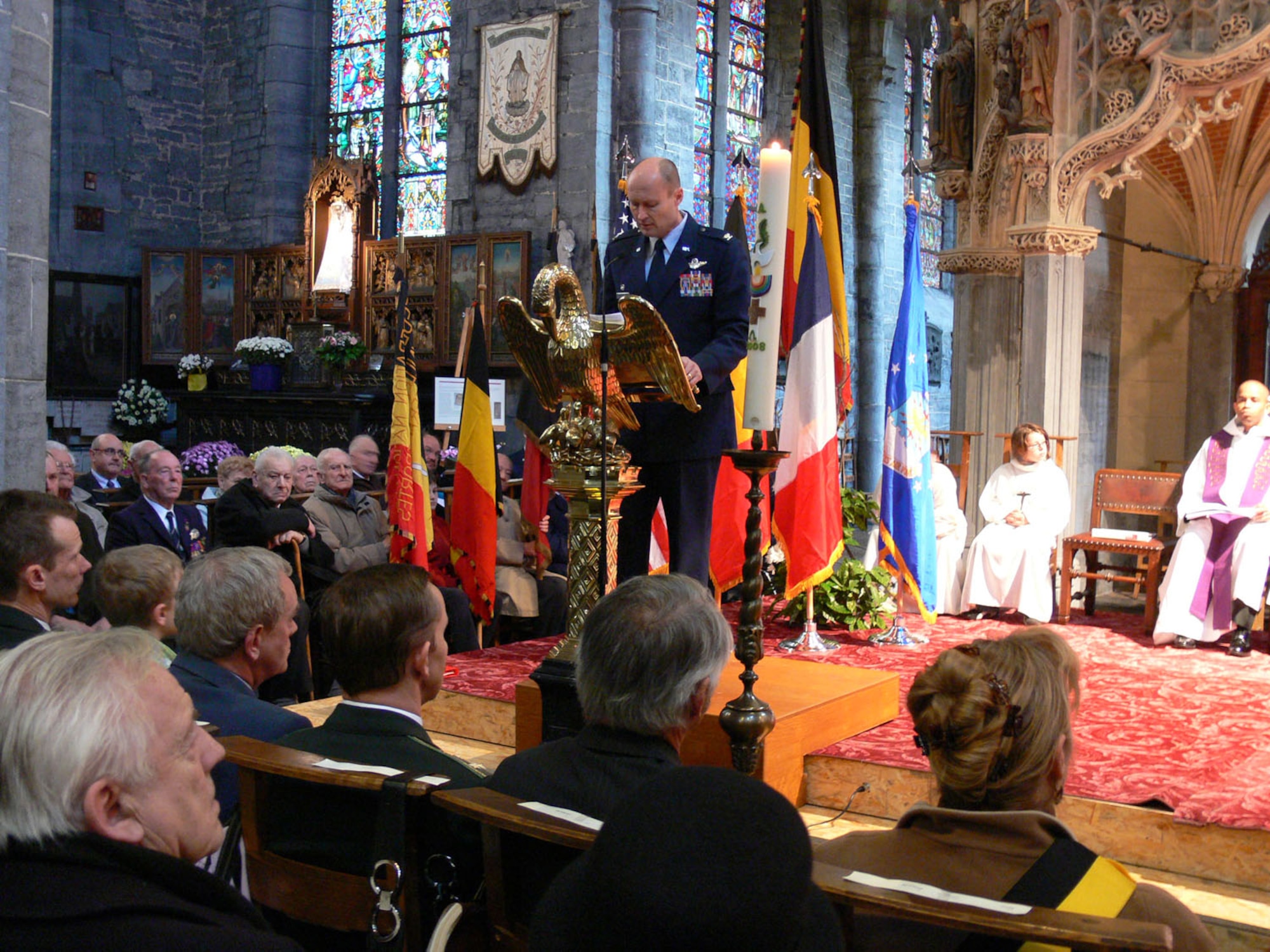 Col. Scott Manning, USAFE Warrior Prep Center commander, delivers remarks about the terrible price of war and the common bonds and enduring friendship between Europeans and Americans during Mass at the Basilica of Our Lady in Walcourt for Armistice Day. Armistice Day, celebrated as Veterans Day in the United States, commemorates the end of World War I and pays tribute to the men and women who fought or were prisoners of war in all wars. (Courtesy photo)