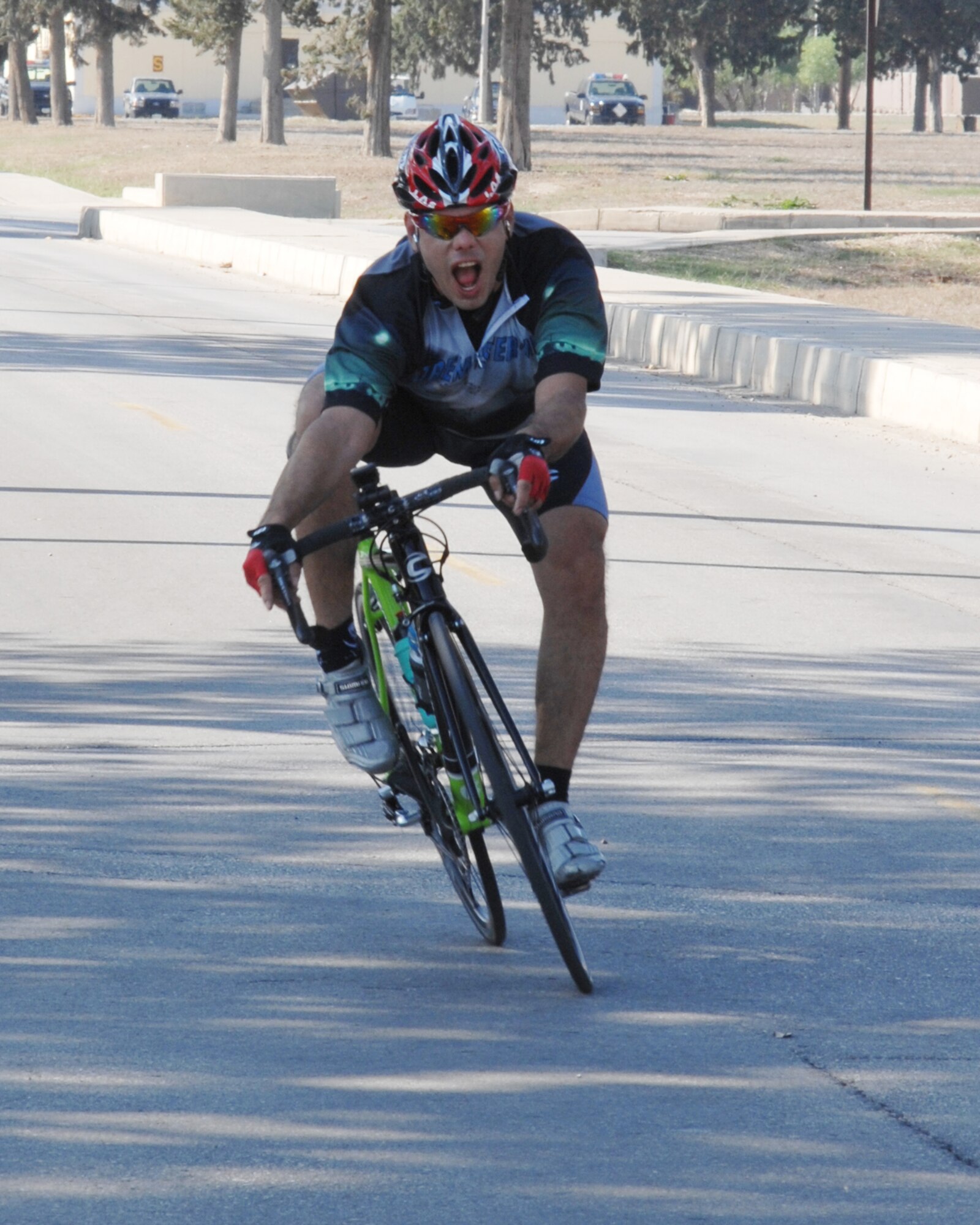 Tech. Sgt. Hector Contreras, 39th Operations Squadron, excitedly crosses the finish line of the 39th Air Base Wing Combined Federal Campaign Bike-a-Thon Nov. 15. The bike-a-thon challenged participants to cycle as many eight-mile laps around the flightline perimeter as they could in two hours. The event raised more than $600 for the CFC.