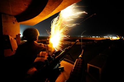 Airman 1st Class Martin Uresti fires a signal flare from an observation tower on Joint Base Balad, Iraq, Nov. 15. Several security forces Airmen were practicing their proficiency deploying signal and illumination flares. Uresti, a security forces apprentice with the 532nd Expeditionary Security Forces Squadron, is deployed from Lackland Air Force Base, Texas. His hometown is Donna, Texas.  (U.S. Air Force photo/Airman 1st Class Jason Epley)