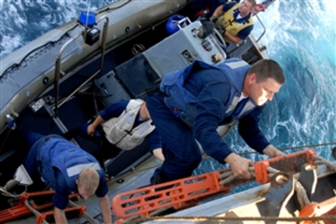 U.S. Navy Petty Officer 2nd Class Keith Sembrat climbs aboard the guided-missile cruiser USS Monterey after a boat officer training evolution in the Gulf of Oman, Nov. 8, 2008. Monterey and the Theodore Roosevelt Carrier Strike Group are conducting operations in the U.S. 5th Fleet area of responsibility.