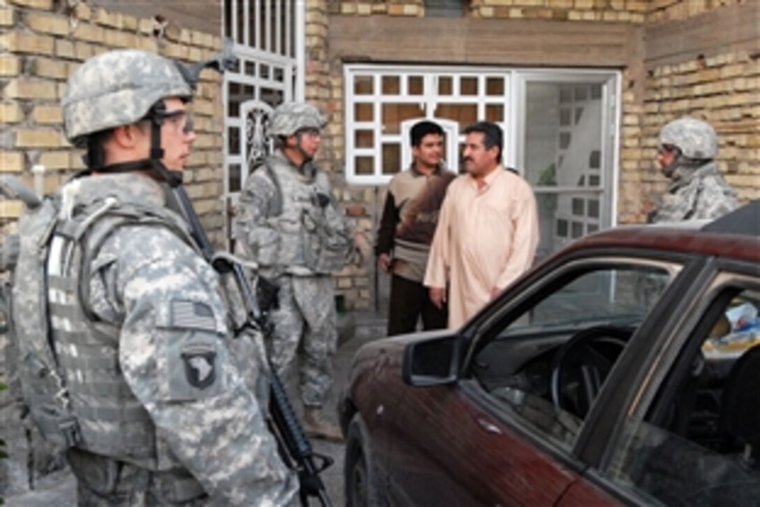 U.S. Army 1st Sgt. Walter Navarro discusses security with a local Iraqi resident, Nov. 11, 2008, in the Hayy Jihad community of the Rashid District of southern Baghdad. Navarro is an armor crew member from Washington, D.C., assigned to Company C, 1st Battalion, 22nd Infantry Regiment, 1st Brigade Combat Team, 4th Infantry Division, Multi-National Division - Baghdad.