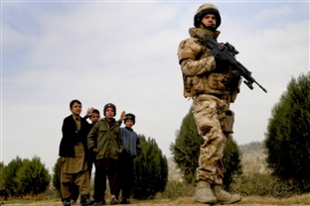 Lance Cpl. Kenny Wilson of Kingston Upon Hill, British Territorial Army, 4th Battalion, Yorkshire Regiment, draws a crowd of children during an International Security Assistance Force patrol around, Afghanistan, Kabul, Nov. 16, 2008. International Security Assistance Force is assisting the Afghan government in extending and exercising authority and influence across the country, creating the conditions for stabilization and reconstruction.