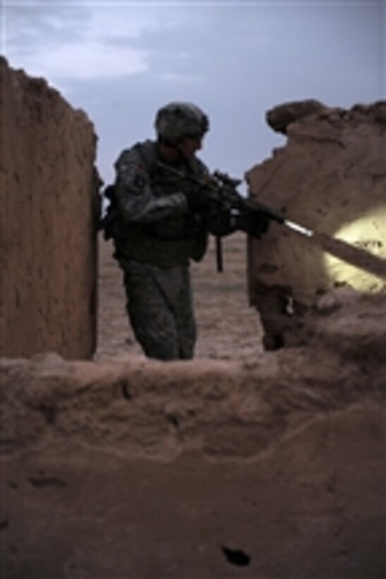 U.S. Army Sgt. William West, from 1st Brigade Combat Team, 101st Airborne Division, searches for weapons caches during an operation in Samarra, Iraq, on Nov. 13, 2008.  