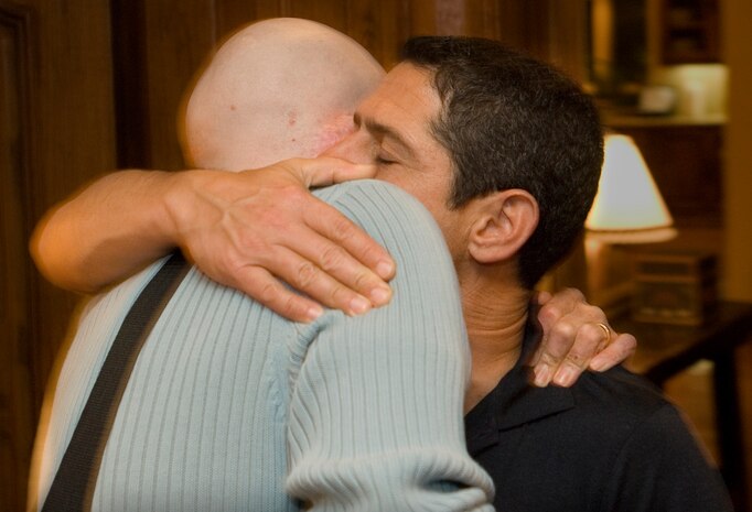 Todd Katz embraces Aaron Mankin as he departs the Katz's home Nov. 17. Todd and Dana Katz hosted the Mankins for dinner during their trip to Los Angeles for Aaron's twelfth surgery at UCLA. Todd, Dana and their children are Operation Mend's premier buddy family, providing friendship and support to Mankin, his wife Diana and their children during Mankin's 12 trips to UCLA. Dana oversees and coordinates the buddy family program. (Official U.S. Marine Corps photo by Staff Sgt. Ethan E. Rocke)