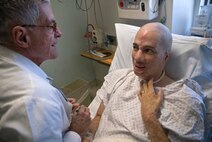 Dr. Timothy Miller, chief of reconstructive and plastic surgery at the University of California Los Angeles Medical Center, shares a laugh with Aaron Mankin during an examination before Mankin's 12th surgery under Miller's knife Nov. 18 at UCLA Medical Center. Mankin was the first wounded service member to take advantage of Operation Mend, a partnership between the U.S. military and UCLA Medical Center, through which UCLA provides world-class plastic reconstructive surgeries to disfigured service members. (Official U.S. Marine Corps photo by Staff Sgt. Ethan E. Rocke)