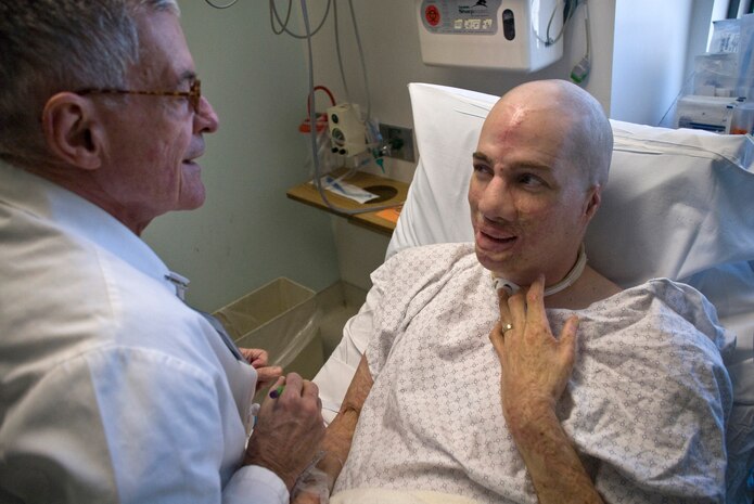 Dr. Timothy Miller, chief of reconstructive and plastic surgery at the University of California Los Angeles Medical Center, shares a laugh with Aaron Mankin during an examination before Mankin's 12th surgery under Miller's knife Nov. 18 at UCLA Medical Center. Mankin was the first wounded service member to take advantage of Operation Mend, a partnership between the U.S. military and UCLA Medical Center, through which UCLA provides world-class plastic reconstructive surgeries to disfigured service members. (Official U.S. Marine Corps photo by Staff Sgt. Ethan E. Rocke)