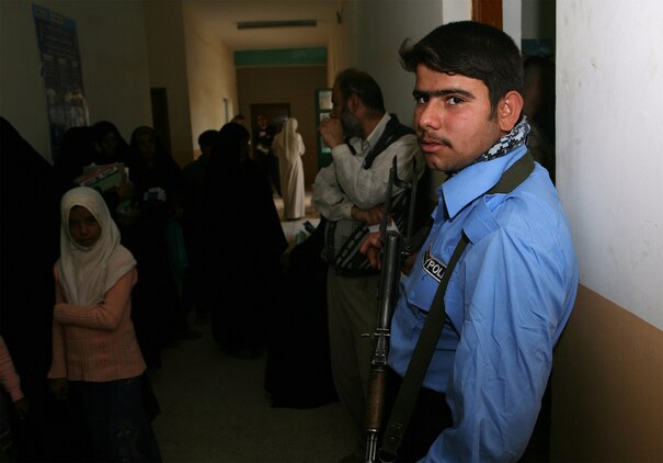 An Iraqi Police officer provides security during a recent cooperative medical engagement led by the Saqlawiyah City Council and Marines with Company B, Task Force 1st Battalion, 2nd Marine Regiment, Regimental Combat Team 5. In the midst of a battalion-wide movement to RCT-5's area of operations, efforts like the medical engagement continued until Marines departed the area.