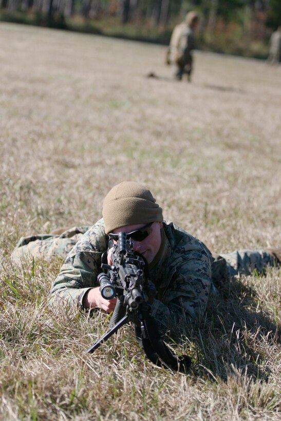 Cpl. William McManigle, a platoon sergeant with Company A, 1st battalion, 8th Marine Regiment, 2nd Marine Division, practices platoon attacks during an exercise here Nov. 19.  After recently spending time in Fort Pickett, Va., doing the same training, the Marines trained hard to keep this important combat training fresh in their heads.  (Official Marine Corps photo by Cpl. Thomas J. Hermesman) (URELEASED)