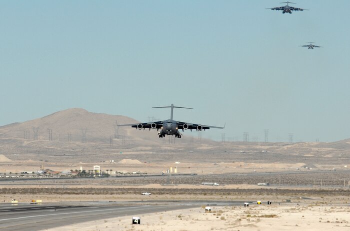 A formation of C-17 Globemasters prepares to land during the Mobility Air Forces Exercise, MAFEX, Nov. 19, 2008, Nellis Air Force Base, Nev. Approximately twelve U.S. Air Force bases participate in MAFEX at the U.S. Air Force Weapons School twice a year, testing C-17 Globemasters and C-130 Hercules crews’ ability to join together in formation at a specific time and location to drop a brigade-size force anywhere in the world. (U.S. Air Force Photo by/Senior Airman Larry E. Reid Jr.)