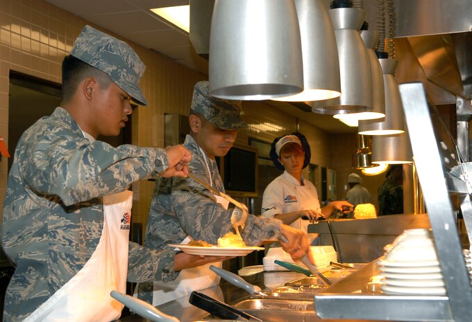 Food service specialists Airman Basic Timothy Audea, Airman William Nicholas and Airman 1st Class Carly Cooper man the front line during lunch rush at the Crosswinds Dining Facility here Nov. 18. The 99th SVS won the Air Combat Command Hennessy award and is now competing on the Air Force level. (Air Force photo by Senior Airman Oleksandra Manko)